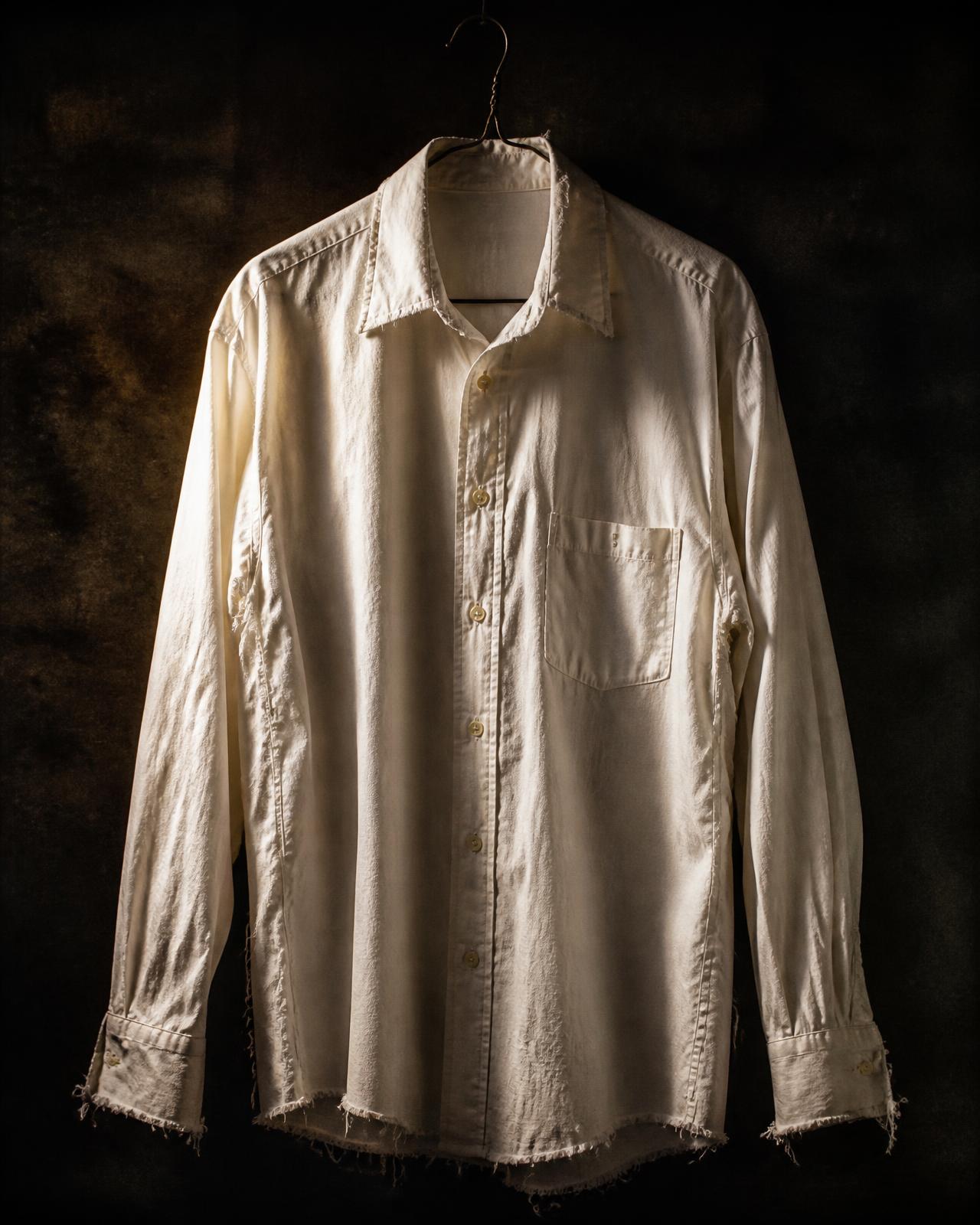 A pressed white shirt fraying at the collar and cuffs